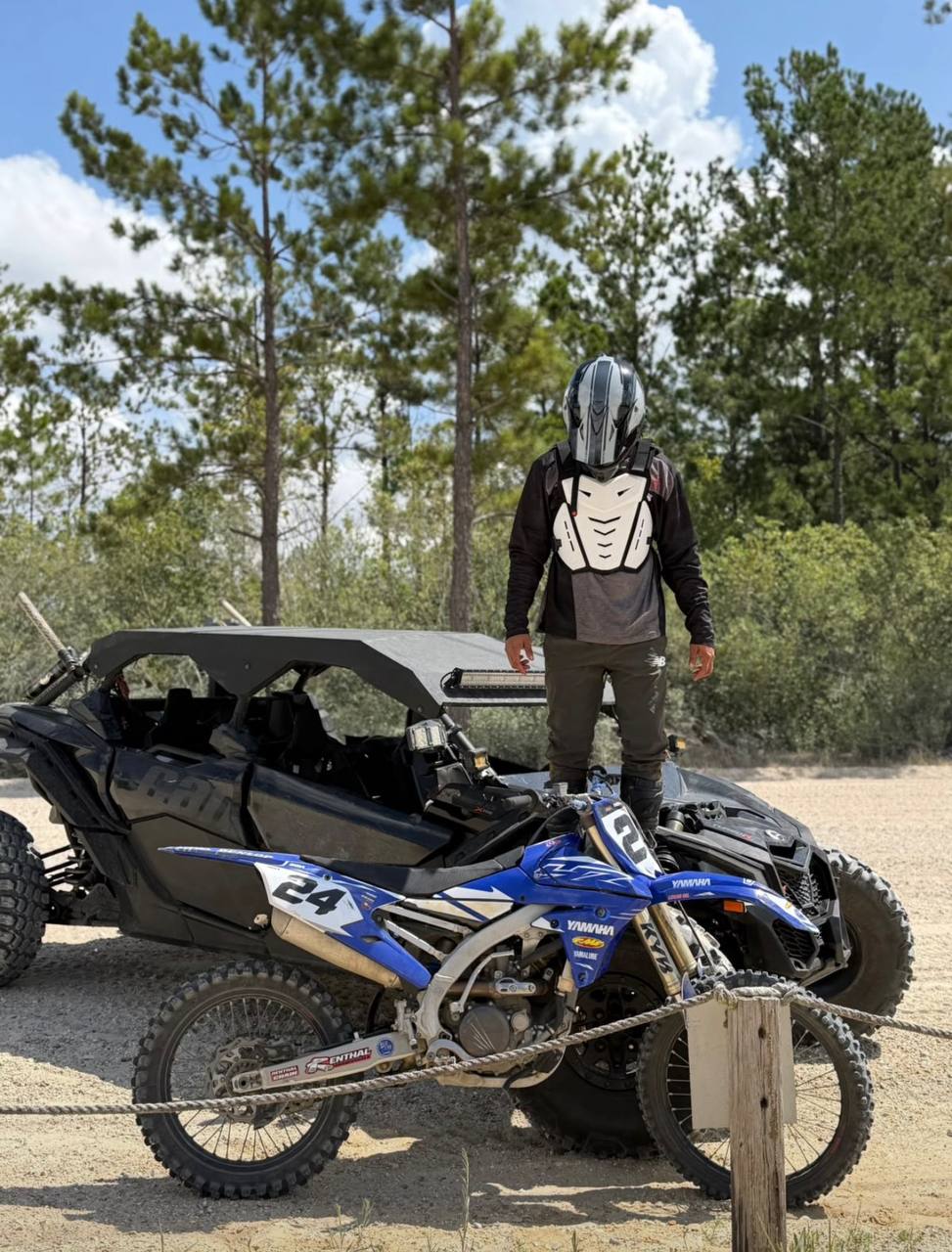 Moto de cross Yamaha frente a un Can-Am negro